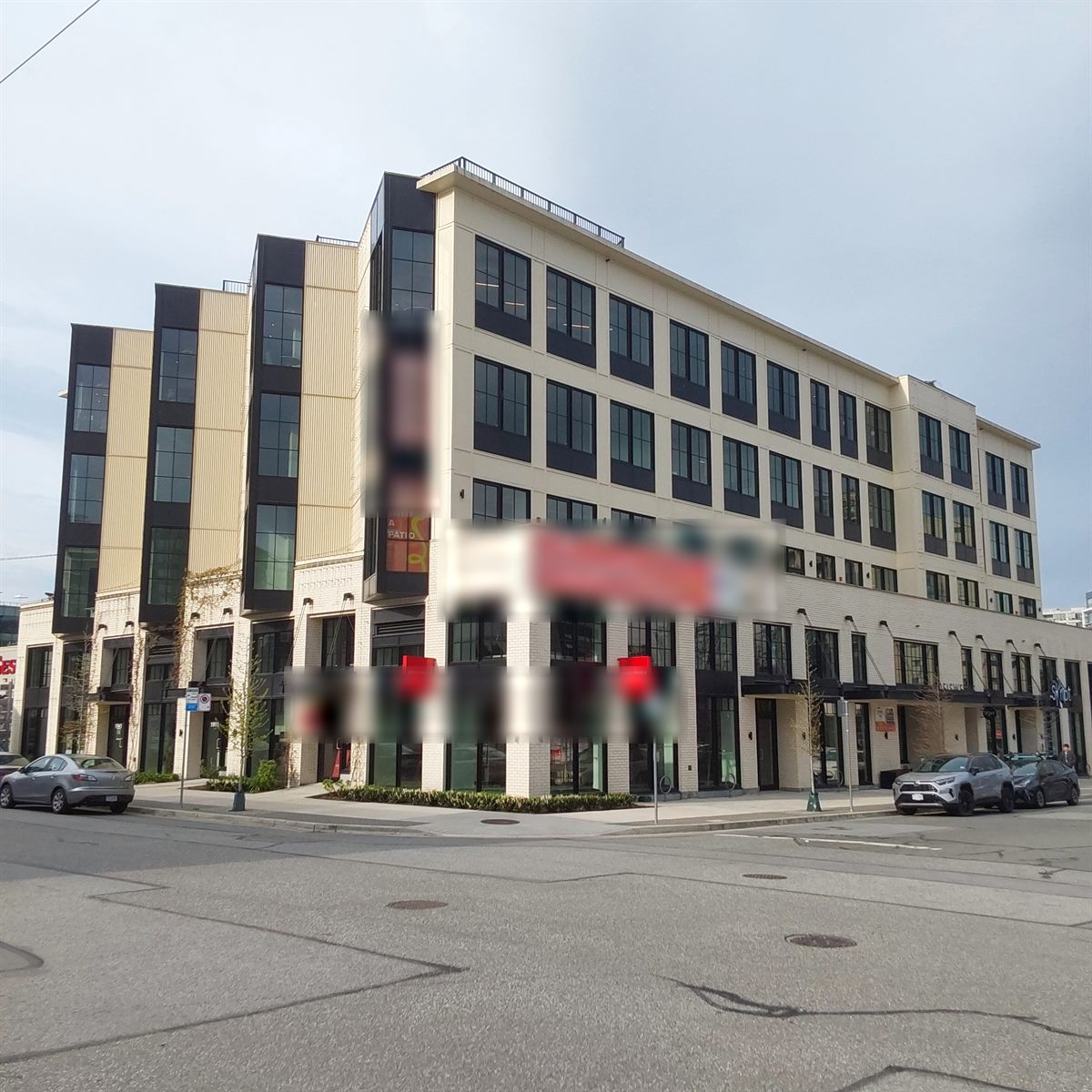 Five-storey mixed commercial low-rise on a street corner, Vancouver