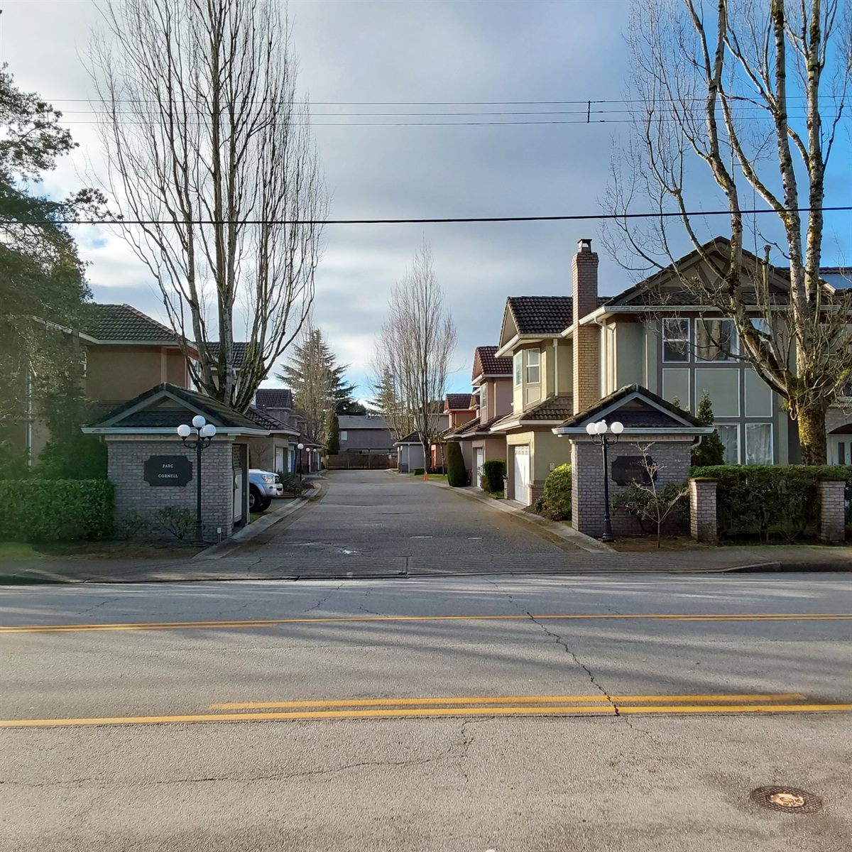 Two-storey strata duplex homes on a tree-lined street, Richmond