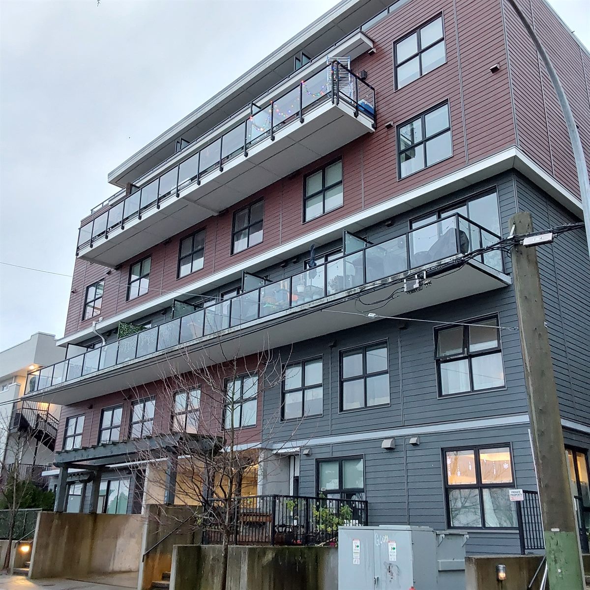 Four-storey stacked townhomes with glass balconies, New Westminster