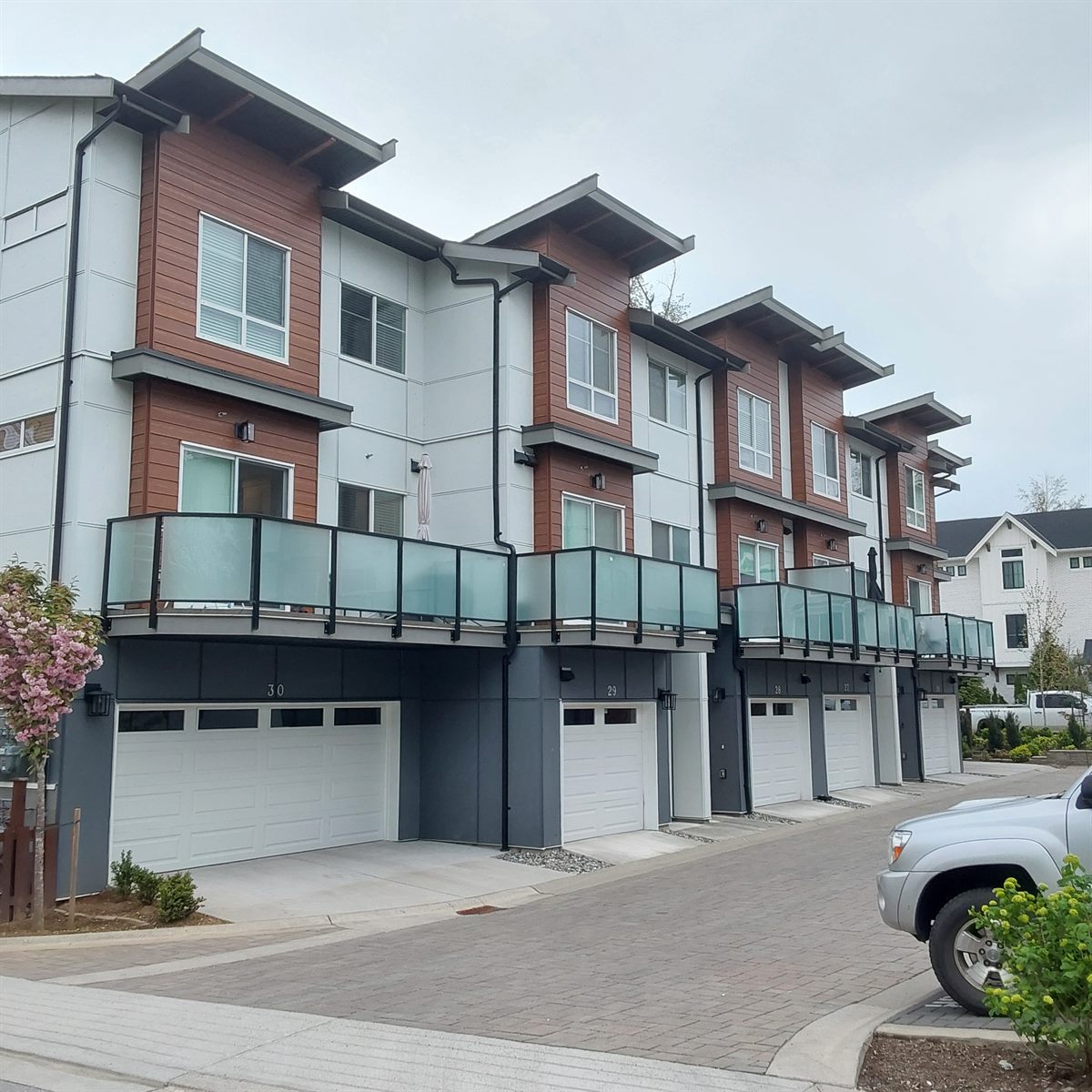 Contemporary wood-and-grey townhomes with private garages, Langley